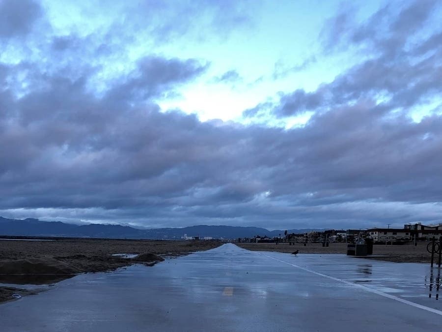 Clouds roll in over a blue sky at the beach in Southern California.