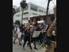 People protest along Wilshire Boulevard in Santa Monica.