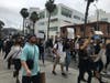 People protest along Wilshire Boulevard in Santa Monica.