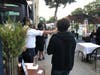 An employee at Pasjoli checks a local's temperature before dining outside on Main Street in Santa Monica.