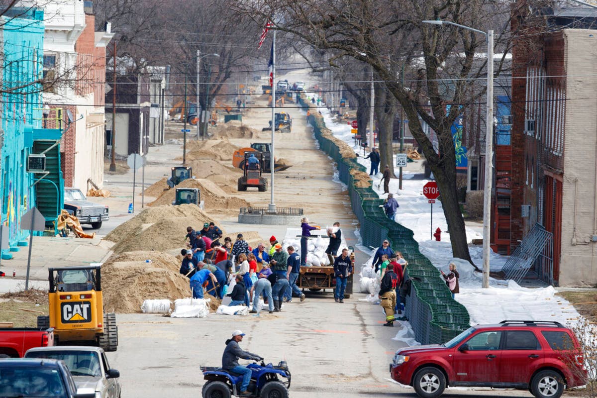 Hamburg, Iowa, residents fill sandbags for a retaining wall to defend their town against the flooding Missouri River.