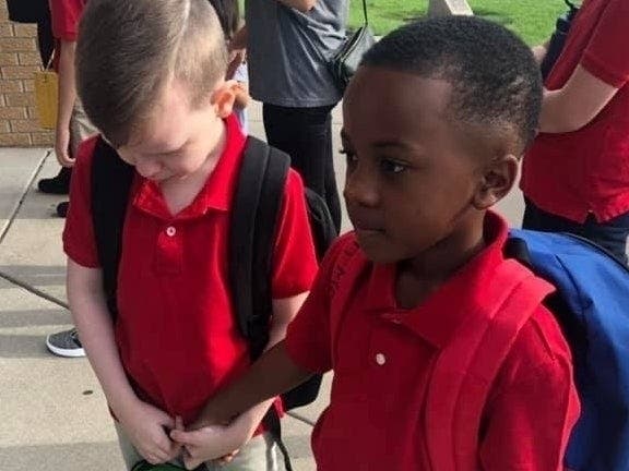 Eight-year-old Christian Moore, right, saw his classmate Connor Crites crying on the first day of school in Wichita, Kansas, and took his hand in a simple but powerful gesture of kindness that is touching hearts around the world. 