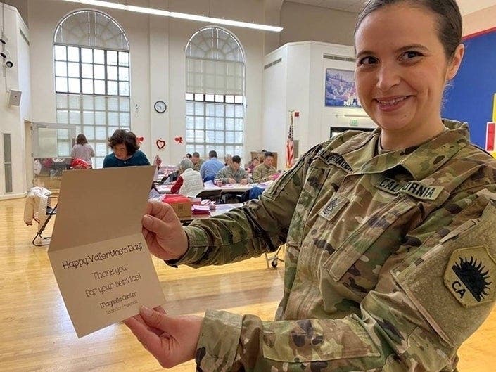 California National Guard Master Sgt. Rebecca Wolkenhaur displays a homemade card she received from the residents of a senior citizen care center participating in “Operation Valentine.”