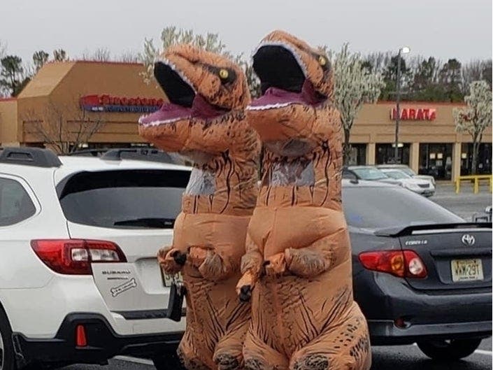 To help their neighbors escape from dire news about the spread of the new coronavirus, two people put on dinosaur costumes before stopping at a supermarket in New Jersey. They shopped leisurely, observing social distancing.