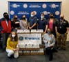 Treasurer Damian Hernandez, Jessica Rudnicky, Member and Morris County Surrogate Heather Darling, Cain Pope, Owner of Luigi’s Pizza Paul Bellardini,  Cady Bye, Recreation Director Brett Douglass. Kneeling is Eva Scartozzi and Pantry Director Janet Wald