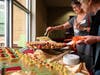 Visitors enjoy tapas treats before touring S.M.A.R.T. model apartments.
