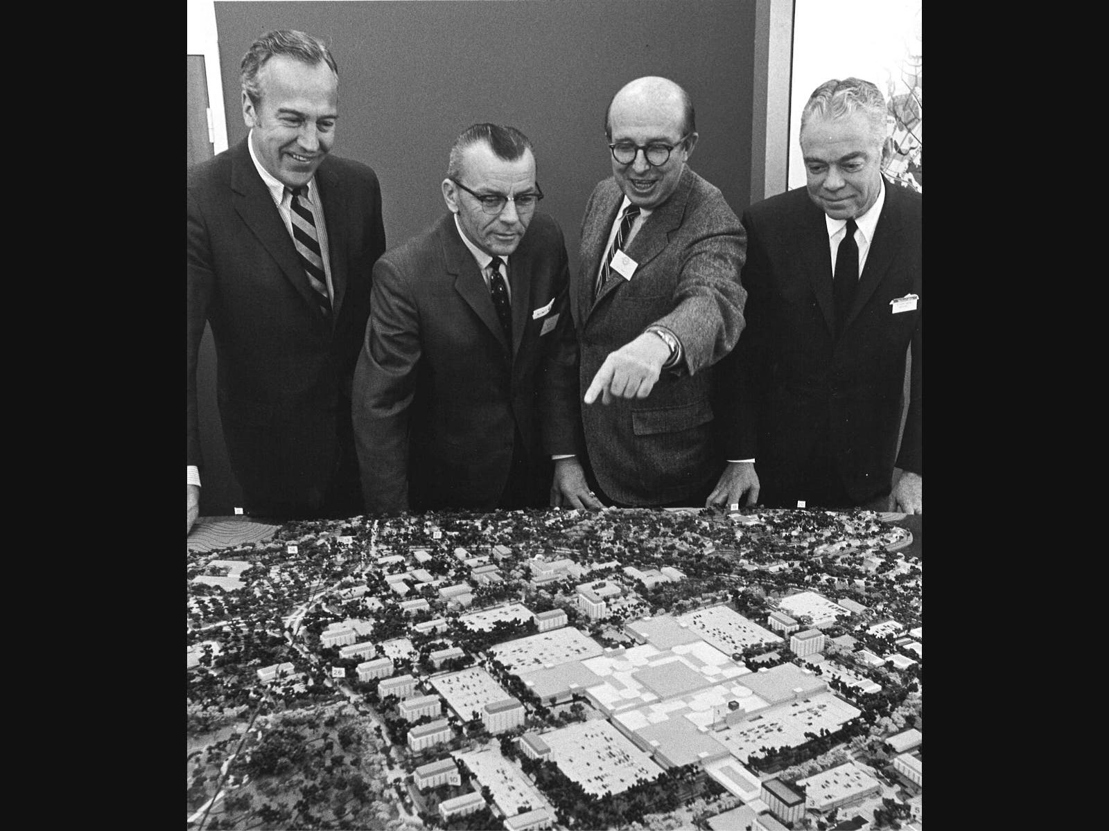 In this historic photo, developer James W. Rouse points out features of The Mall in Columbia to (from l.) Woodward & Lothrop Executive Vice President Edwin Hoffman, Howard County Executive Omar Jones, and Woodward & Lothrop President Andrew Parker.