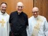 Fr. Norbert receives congratulations from Fr. Ed Howe, CR and Deacon Tom Marciani