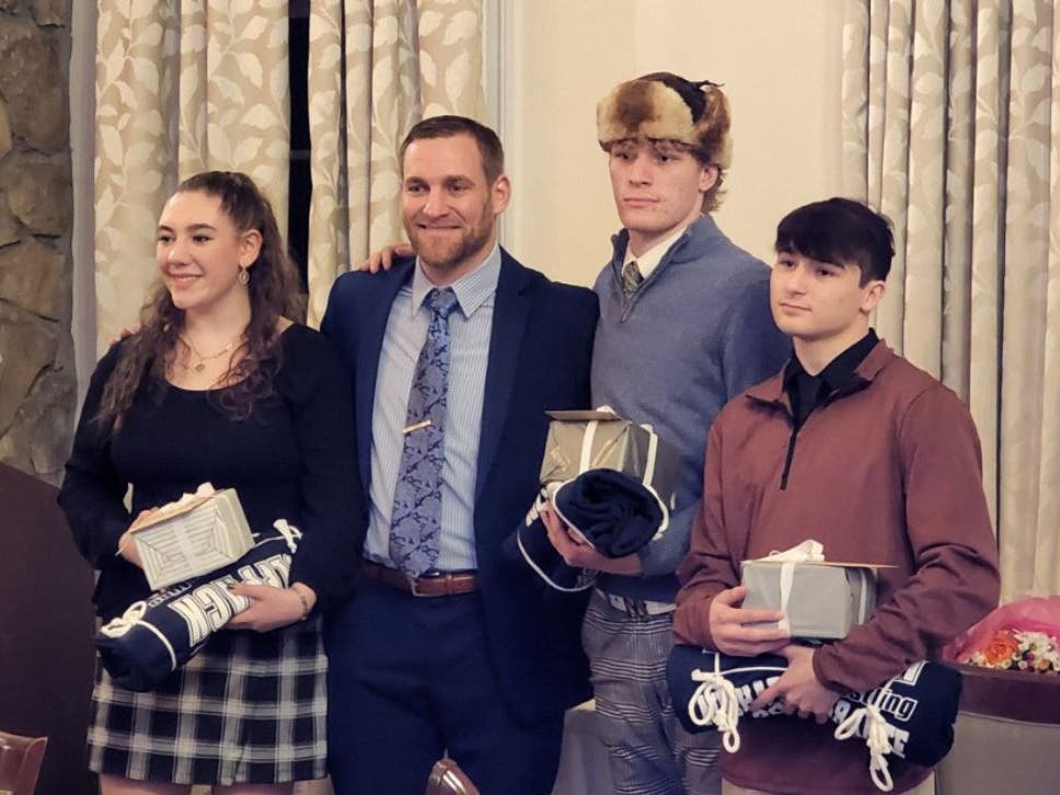 The Wolfpack wrestling banquet celebrated three seniors who are prominent in the WMC record books. From left: Marisa DiPaolo, Coach Chris Marold, Malachi Shepard, and Michael Ferrante.