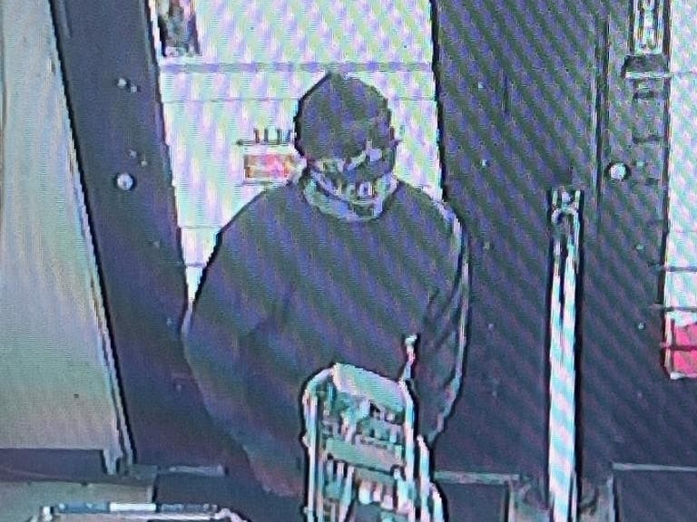 A man seen in surveillance images walked into a Manhattan liquor store early Thursday morning, then emptying the register, police said. 