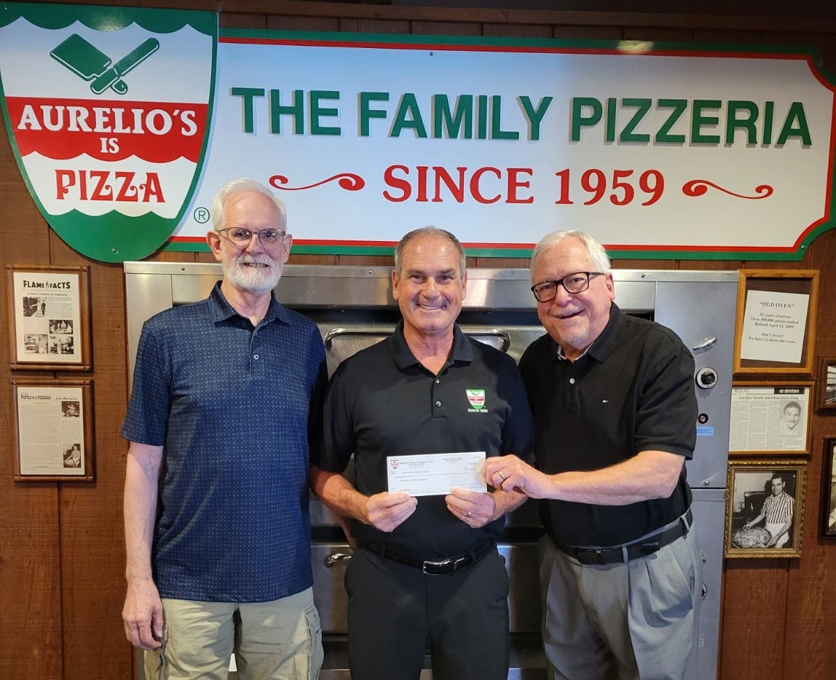 It was a “Fiesta-sized” gift from Aurelio’s Pizza to the Homewood Historical Society,
presented by Joe Aurelio (center) to HHS Treasurer Mark Leschuck (left) and President
Bob Anderson (right).