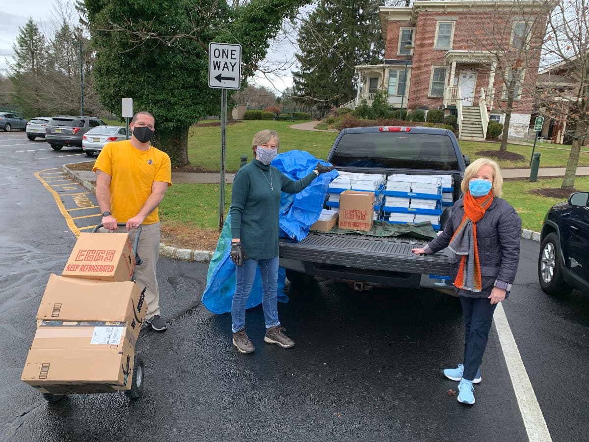 Matt Berke, Colleen Duffy and Deborah Berry-Toon unload pies donated by the First Presbyterian Church of Newton.