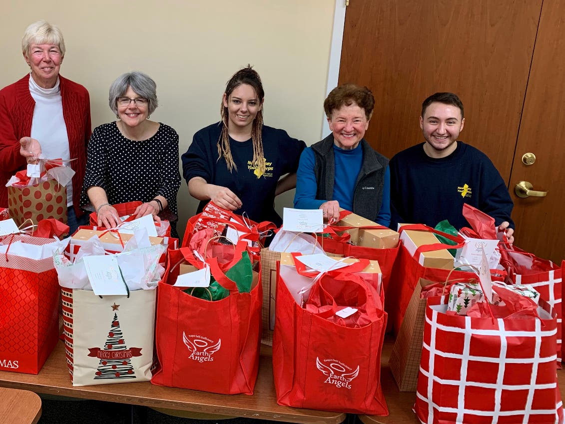 Gift bags are assembled for distribution to local senior citizens in need as part of Project Self-Sufficiency's Earth Angels initiative.