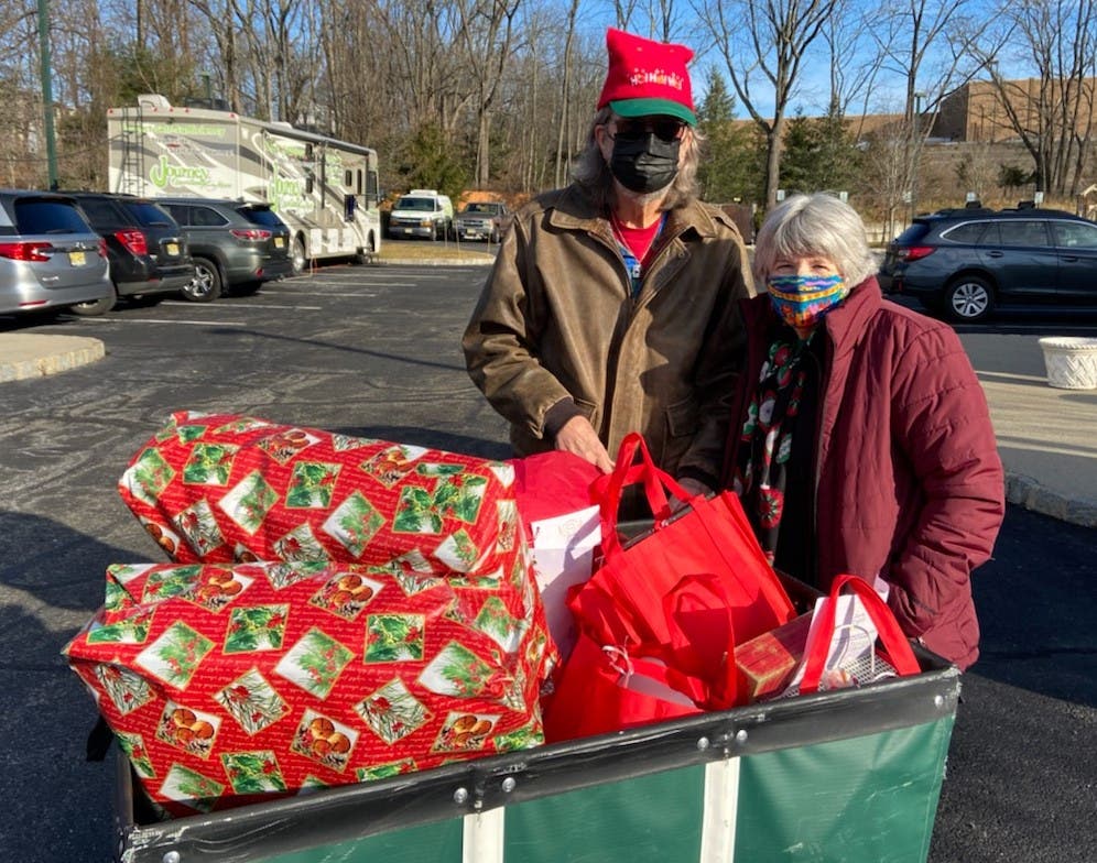 Kevin and Alice Prendergast assemble gift bags for local senior citizens as part of Project Self-Sufficiency's Earth Angels initiative.