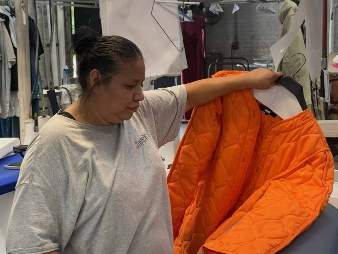 Candelaria Bello, Assistant production Manager at Zengeler Cleaners, processing one of the many items collected during a previous drive