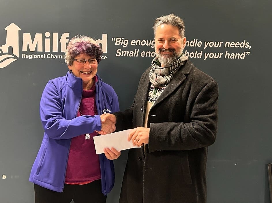 Susan Brown, founder of Purple Pantry Boxes receives a donation from Todd Kipperman of the Milford Chamber's Friday Leads Group.