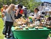 Patrons browse handmade goods at last year’s Milford Artisan Market on the Milford Green.