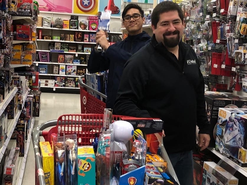 Employees from 1st United Credit Union shopping for toys to donate to Toys for Tots