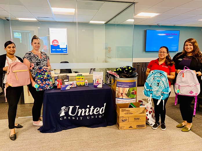 1st United Credit Union employees collecting school supplies