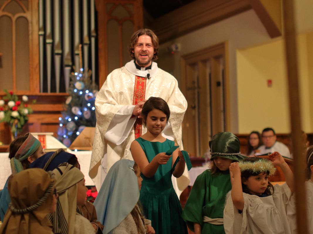 Father Andy and the children at the 2018 Christmas Pageant