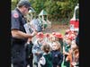 Students receive fire safety books before returning back to their classrooms.