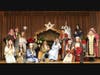 Picture is Jill Nesti, a four-time Emmy-nominated songwriter with eighth grade students in East Shoreline Catholic Academy's "Christmas in Prayer and Song," a liturgical service.