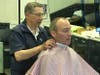 Joseph Vaccarella chats with a customer at Barber Serville. The business will close next month.
