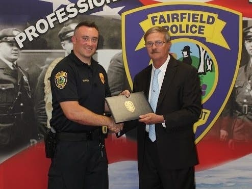 Officer Thomas Gorton is honored last week after saving a child's life in December.