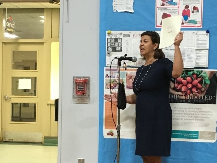 Minority Leader Pamela Iacono holds the Town Charter while speaking at meeting Thursday.