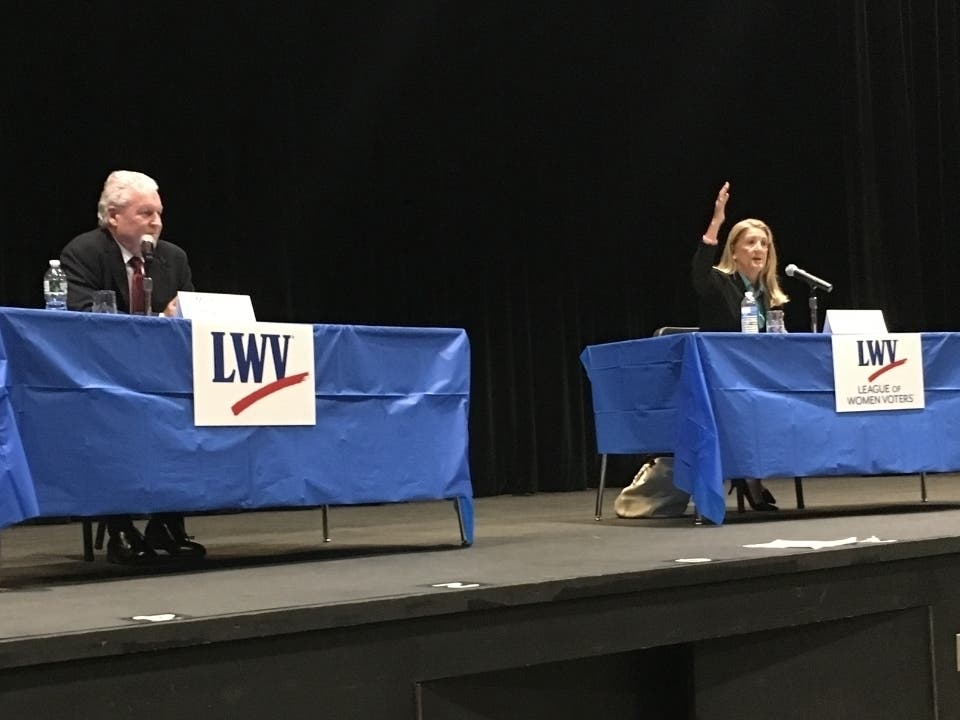 Brenda Kupchick speaks at a debate Wednesday while Mike Tetreau looks on.