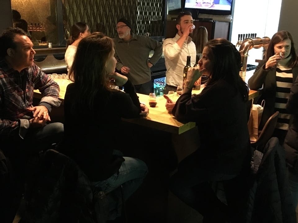 People gather around the bar at J.B. Percival Co. during a free vendor tasting Dec. 5.