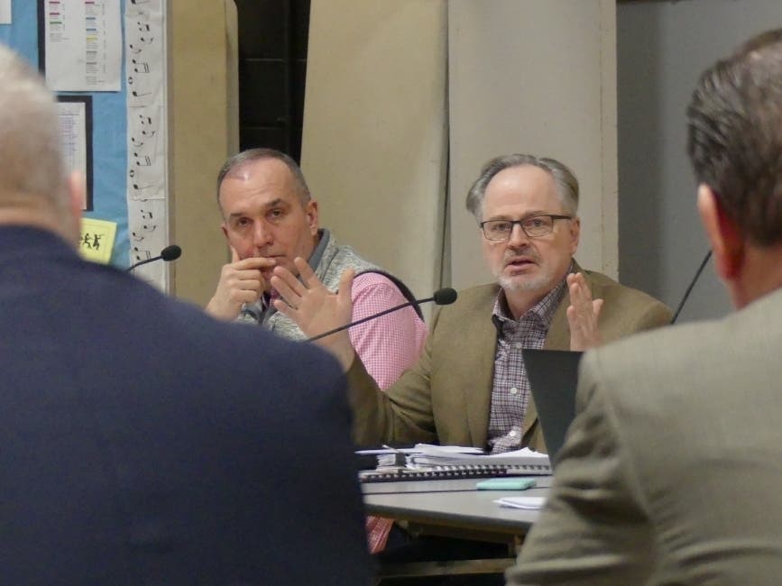 Board of Finance member Ed Bateson speaks Feb. 5 while board member Jack Testani looks on.