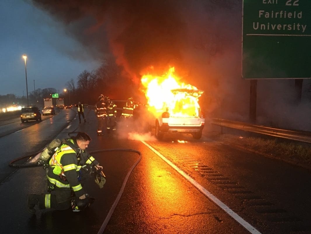 Firefighters respond to an SUV that is ablaze Wednesday on Interstate 95.