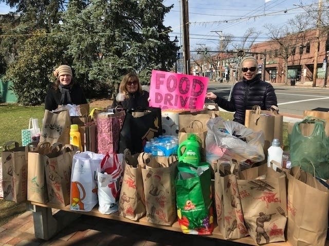 Community members hold a food drive March 15 at Sherman Town Green.