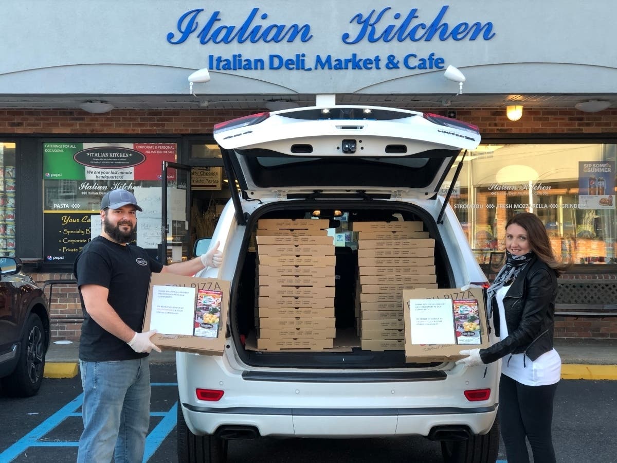 Dominick Giresi Jr. and Paola Giresi bring 50 pizzas Thursday to Bridgeport Hospital.