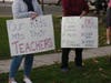 Fairfield parents hold signs during a rally Monday.