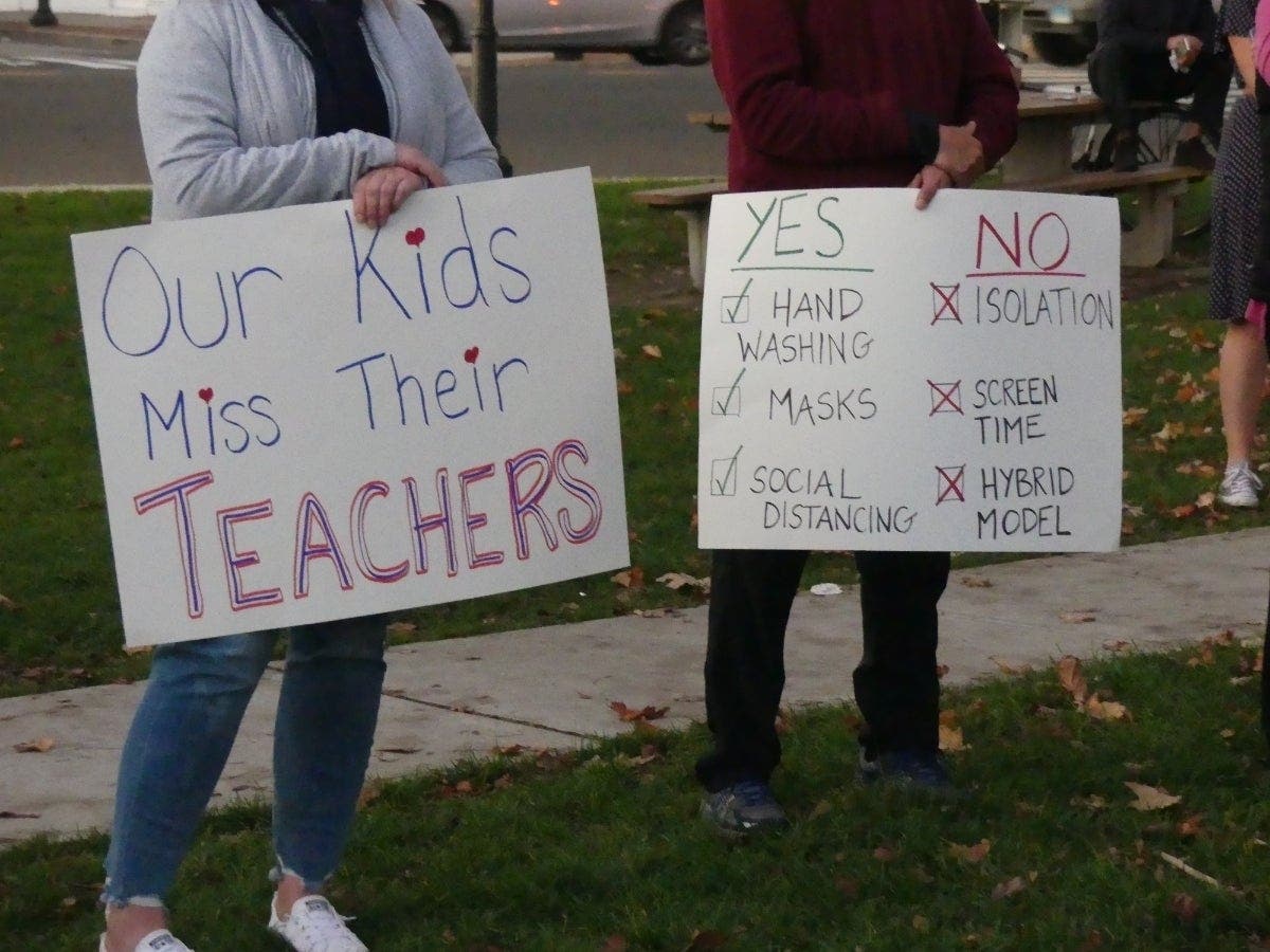 Fairfield parents hold signs during a rally in November.