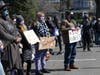 Demonstrators hold signs Saturday at a Stop Asian Hate rally in Fairfield.