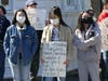 Kathy Trinh (center) holds a sign at a Stop Asian Hate rally Saturday in Fairfield.
