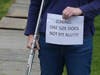 A demonstrator holds a sign at a rally Saturday in Fairfield.
