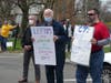 Demonstrators hold signs at a rally Saturday in Fairfield.