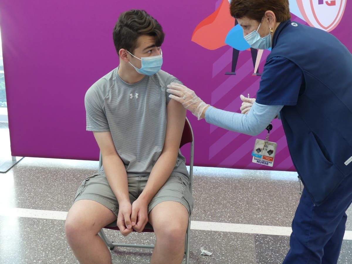 Matthew Loiz is seen seconds after receiving his first dose of the Pfizer vaccine.