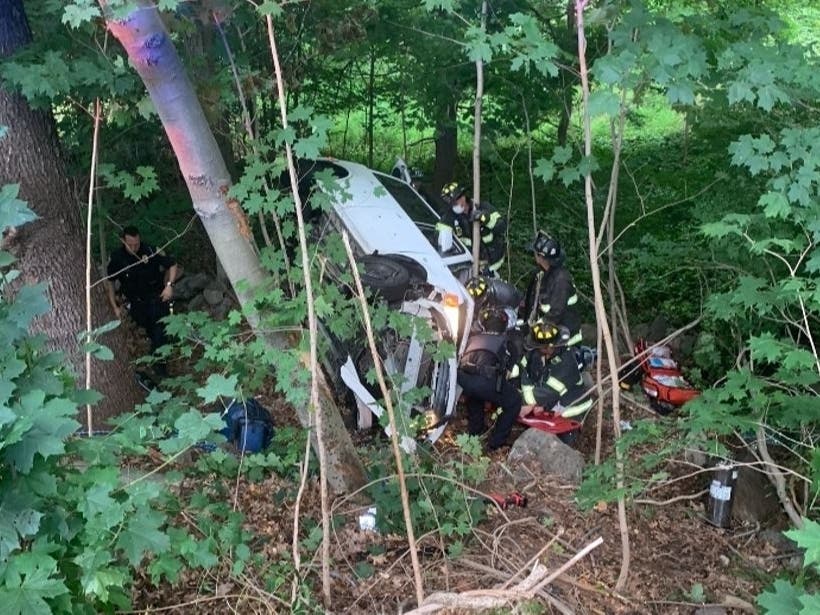Police and fire officials respond Wednesday to a car in an embankment in Fairfield.