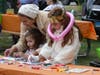 Sevtap Kaplan (in hat), Ada Kaplan (right) and Mila Kaplan work on an art project Sunday.