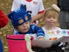 Jack Armstrong and Allison Liberty stop by the candy bowl at the Gymnastics and Cheerleading Academy table.