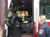 Aspiring firefighter Nash McFadyn takes a turn behind the wheel as Fairfield firefighter Tim Firla looks on.