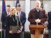 Selectman Tom Flynn speaks Thursday while First Selectwoman Brenda Kupchick looks on.