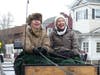 Debbie Breece (left) and Carrie Wind of Allegra Farm drive one of the horse-drawn wagons Sunday.