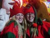 Elves Kaili Jacobsen (left) and Anna Burgess are among Santa's entourage.