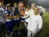 Darien players and fans are all smiles after a state title win Saturday.